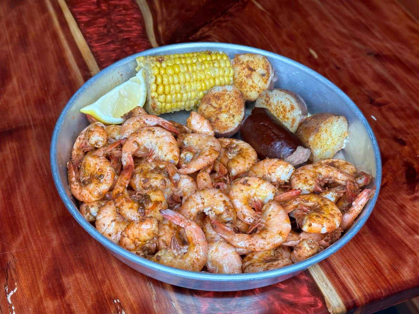 Seasoned boiled shrimp with corn, sausage, potatoes and lemon